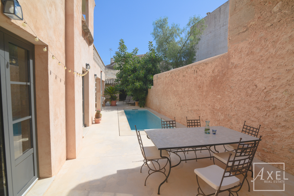 Elegante casa adosada en Campos, recién reformada, con patio, piscina y encanto histórico.
